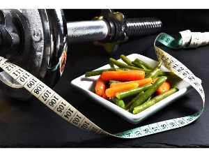 barbell with plate of food and a measuring tape